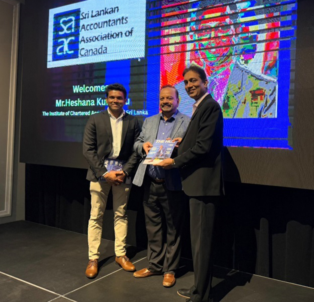 Mr. Heshana Kuruppu and Mr. Niluka Abeygunaratnepresenting a copy of the “The Hub Canada” magazine at the event organised by the Sri Lankan Accountants Association of Canada