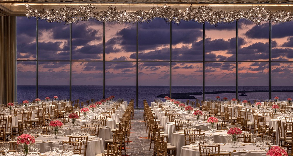 The Sangam Ballroom dazzles with elegant details, accommodating over 800 guests amid sweeping Indian Ocean views through floor-to-ceiling windows