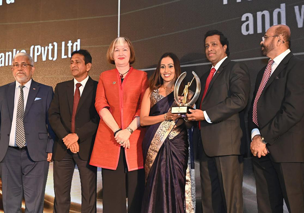 Kaushala Amarasekara receives her award from Pradeep Saputhanthri, Secretary to the Prime Minister (second from right). Also pictured (from left): Admiral Thisara Samarasinghe, Former High Commissioner of Sri Lanka to Australia and Former Commander of the Sri Lanka Navy; Aruna Bandara, Secretary, Ministry of Youth Affairs and Sports; Ms. Joni Simpson, Country Director, International Labour Organisation Office in Sri Lanka; and Anura Siriwardena, Chairman, Global CEO Forum and Managing Director, Voice of Asia Network (far right).