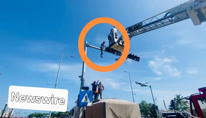 Presidential appointment ? Youth climbs traffic post, gets Arrested instead