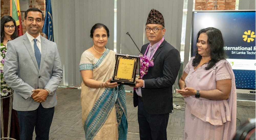 Prof. Chandrika N. Wijeyaratne, Vice Chancellor of Sri Lanka Technology Campus is awarding a token of appreciation to H.E. Dr. Purna Bahadur Nepali, H.E.Dr.Purna Bahadur Nepali is accompanied by Dr.Deepika Priyadarshani , Chair of the International Research Conference 2025 on left and Dr.Lakshitha Pahalagedara ,Dean Faculty of Postgraduate Studies & Research on right