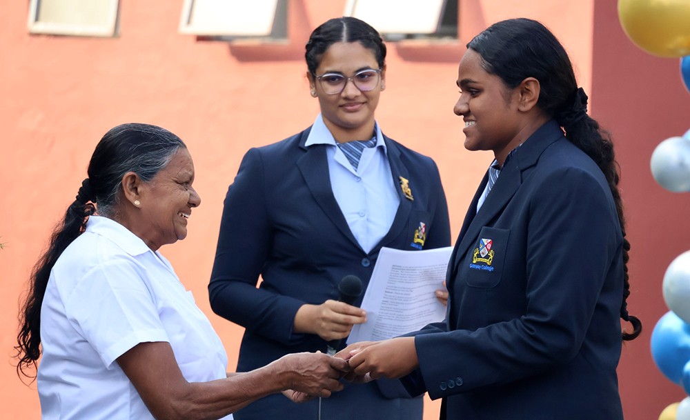 Student handing over voucher to a member of support staff